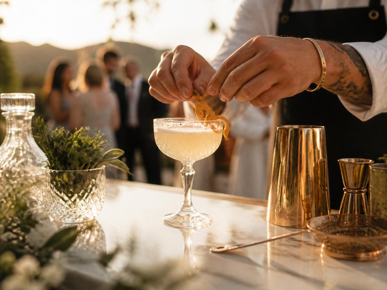 Bartender crafting an elegant cocktail on marble bar